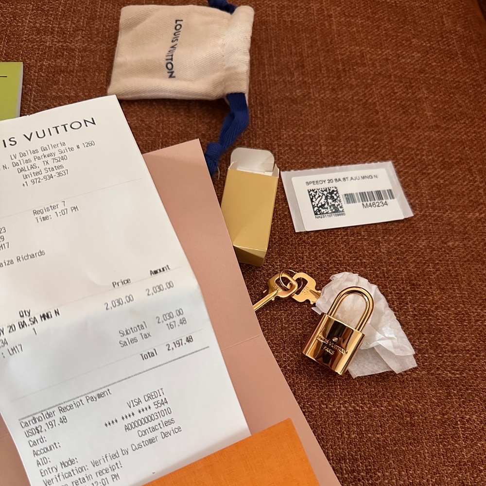 Louis Vuitton lock with key and dirt bag
